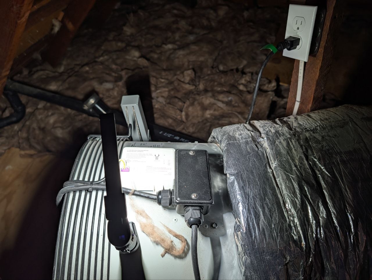 The Solatube WHF3000 installed in the attic — shows the fan unit, ductwork, wiring, and outlet setup
